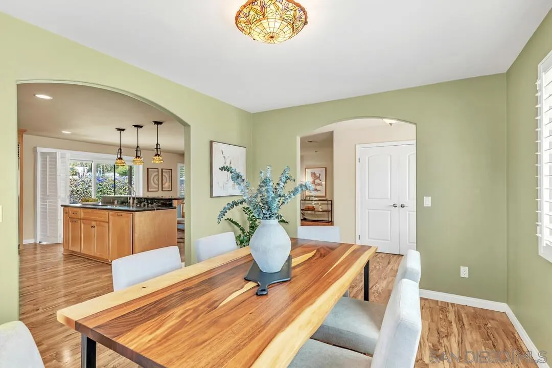 14228 Frame Road Poway, CA 92064 - Photo 4 of 49 a dining room with wooden floor and a chandelier