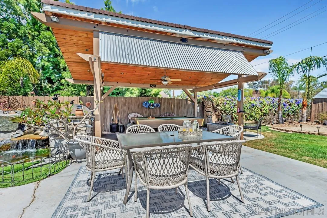 14228 Frame Road Poway, CA 92064 - Photo 43 of 49 a view of a patio with a table chairs and a backyard