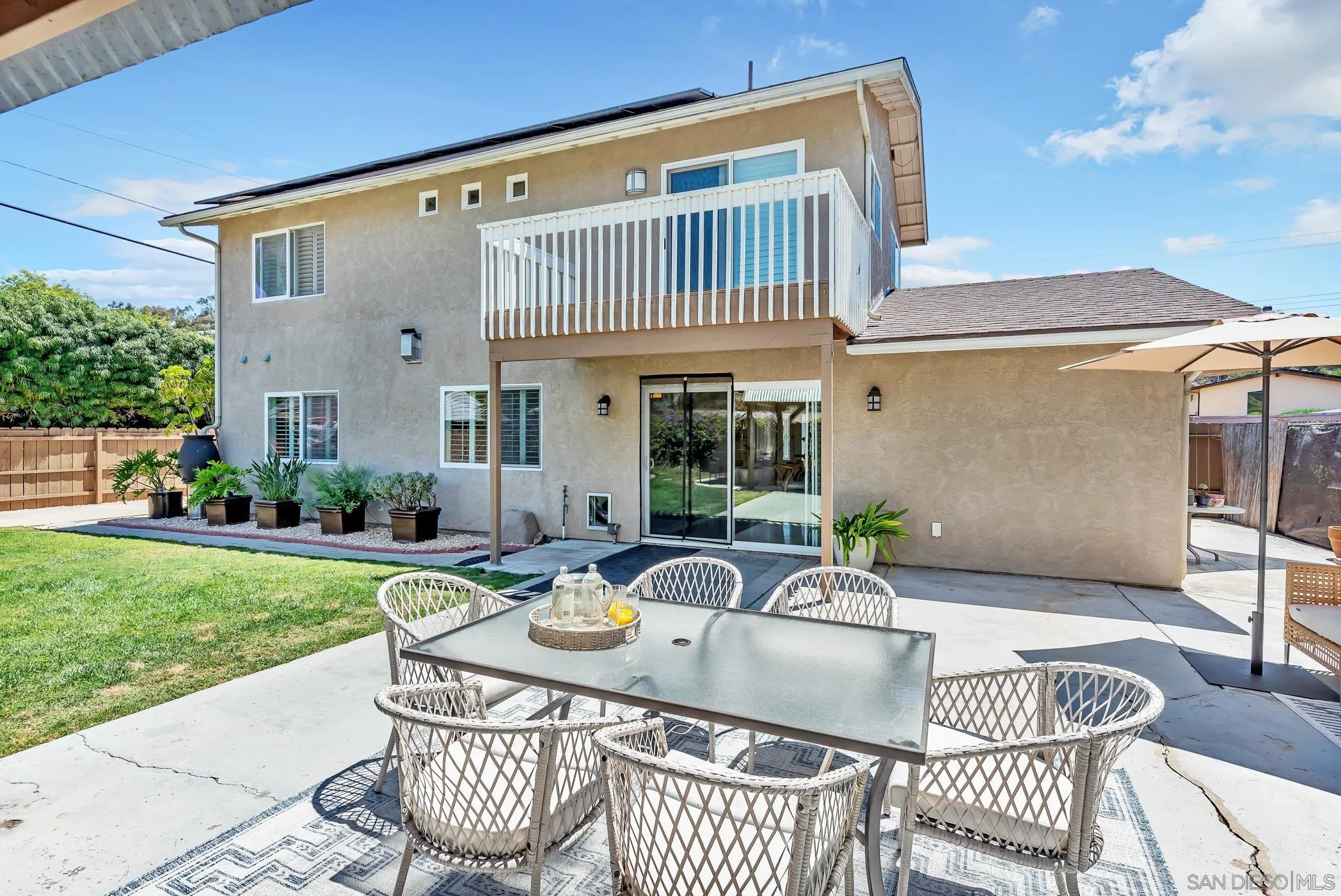 14228 Frame Road Poway, CA 92064 - Photo 45 of 49 a view of a patio with table and chairs and potted plants