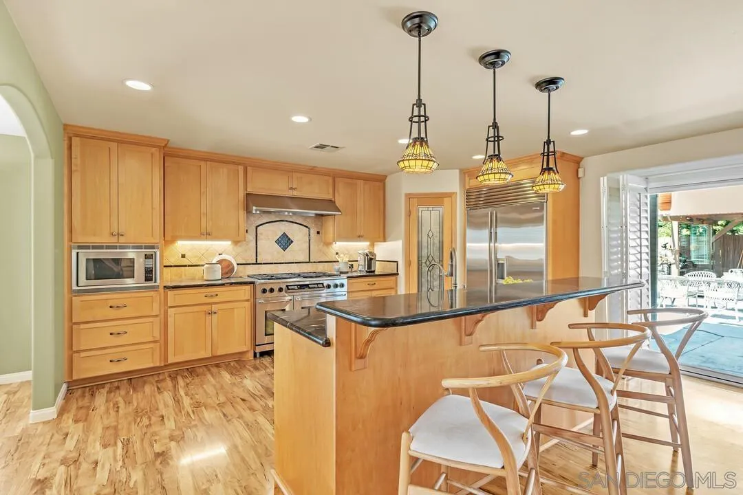 14228 Frame Road Poway, CA 92064 - Photo 7 of 49 a kitchen with stainless steel appliances granite countertop a sink and cabinets