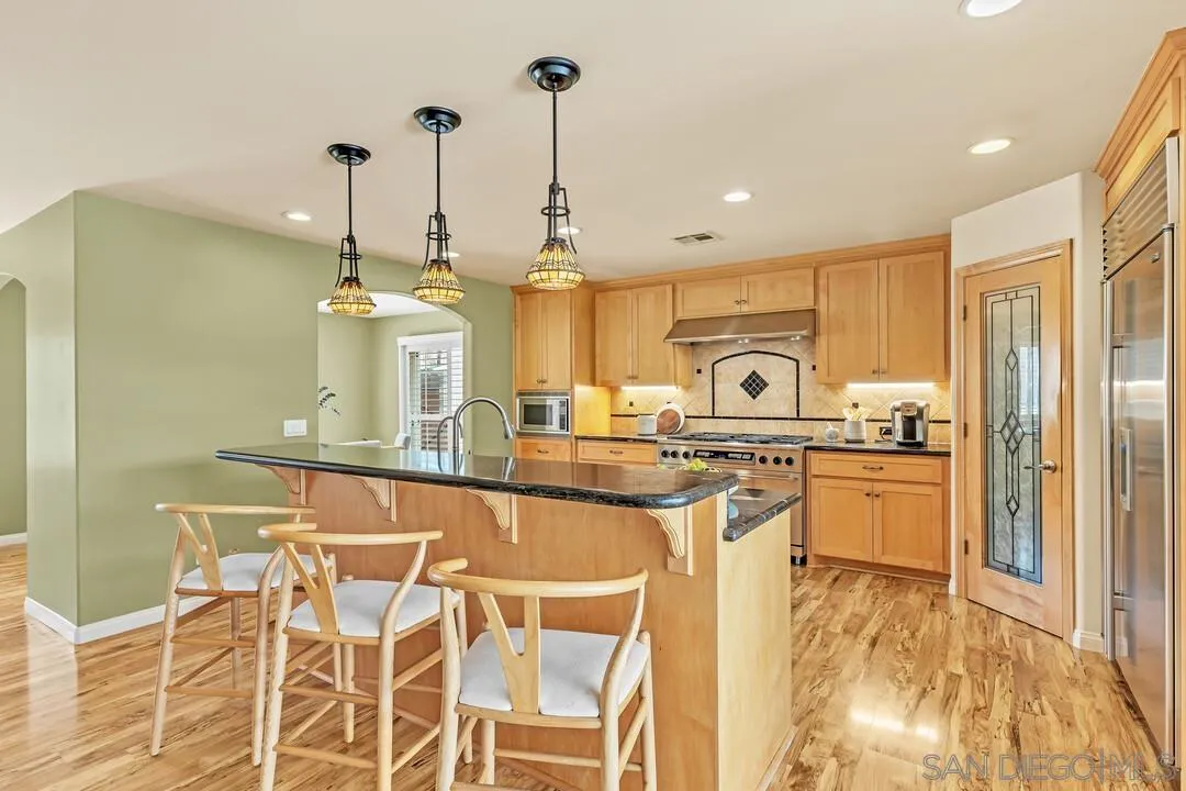 14228 Frame Road Poway, CA 92064 - Photo 8 of 49 a large kitchen with granite countertop a sink counter space appliances and cabinets