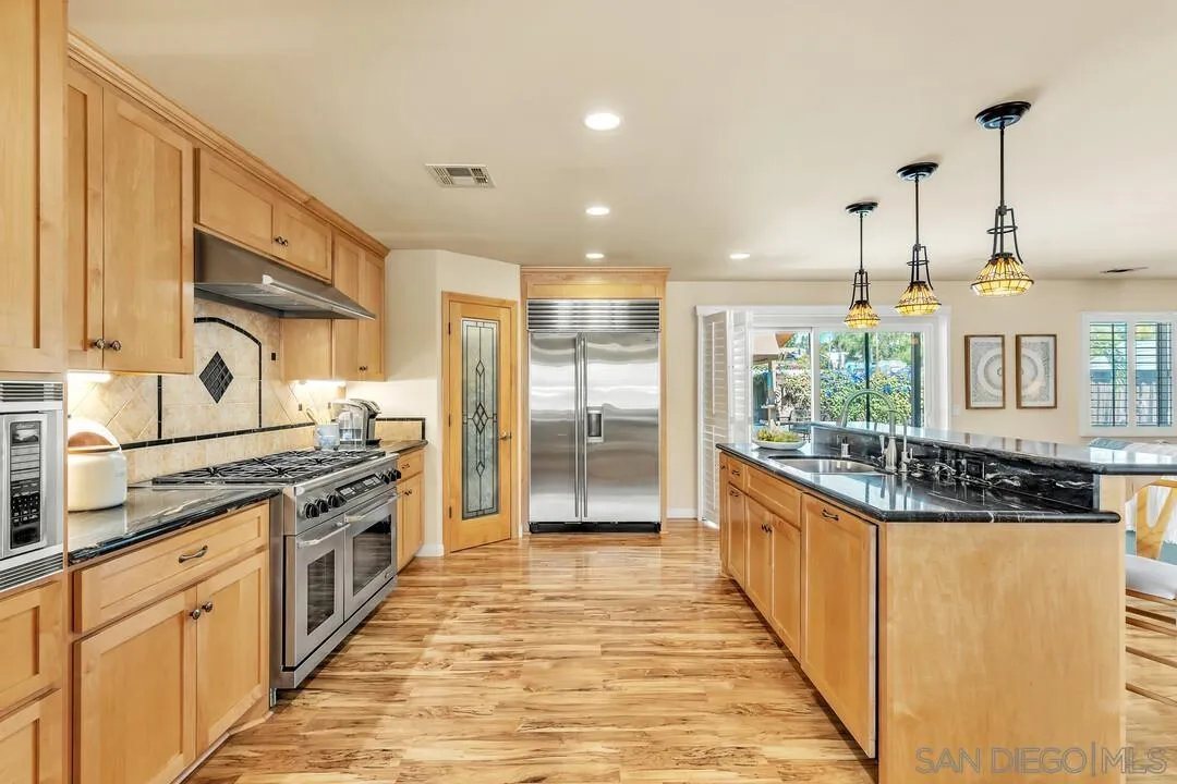 14228 Frame Road Poway, CA 92064 - Photo 9 of 49 a kitchen with stainless steel appliances granite countertop a stove a sink and a refrigerator