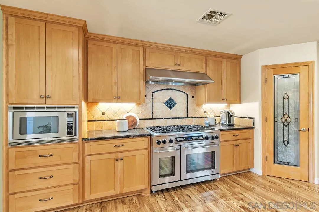 14228 Frame Road Poway, CA 92064 - Photo 10 of 49 a stove top oven sitting inside of a kitchen