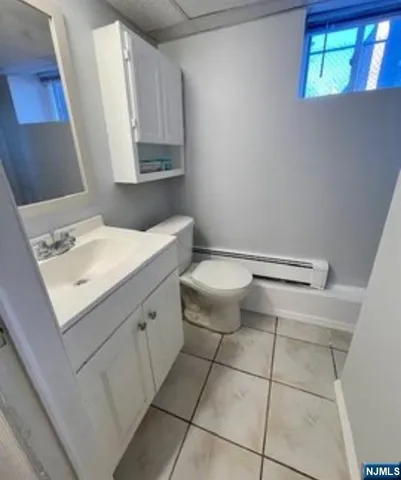 a bathroom with a sink a toilet and mirror