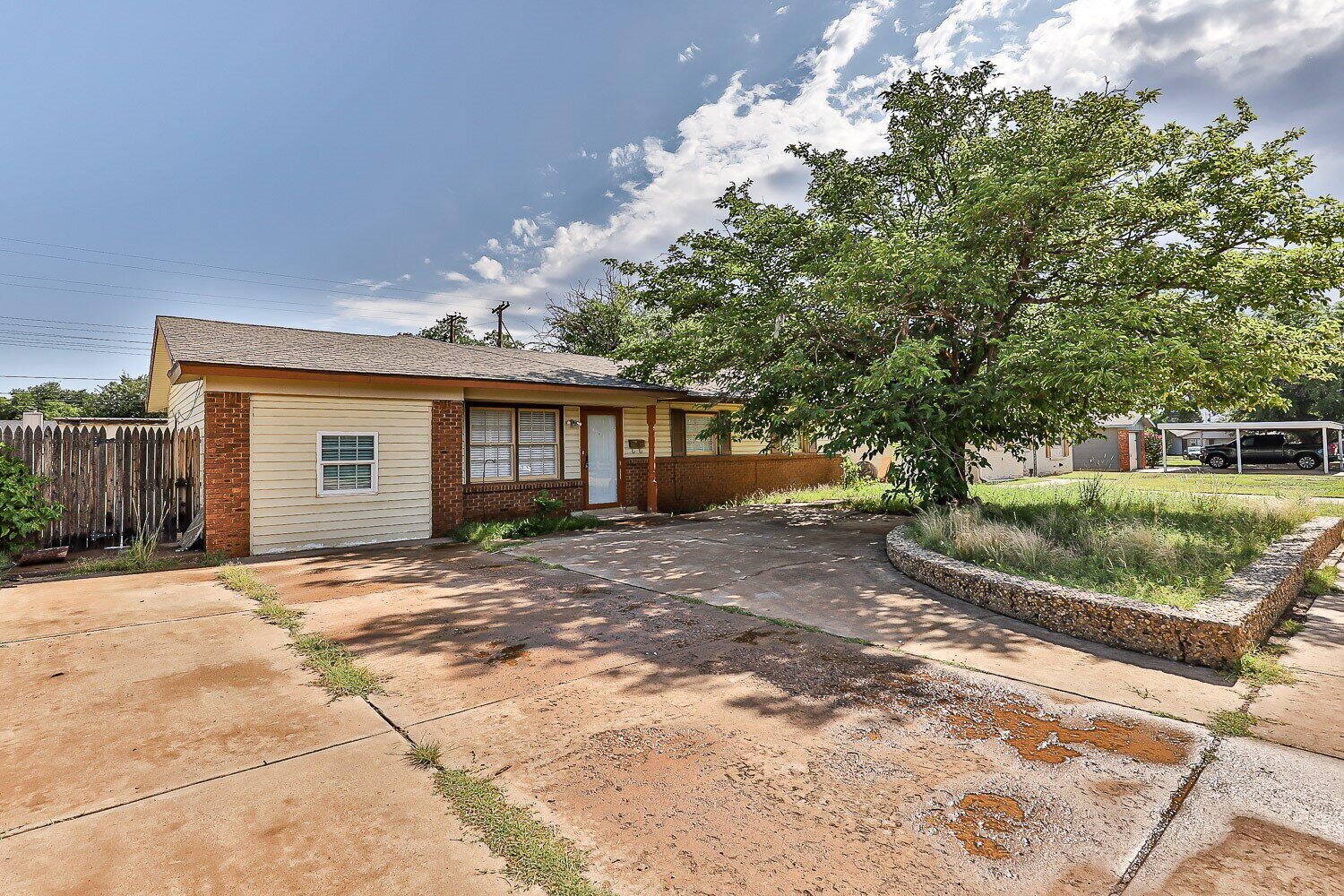 a view of a house with a tree in front of it