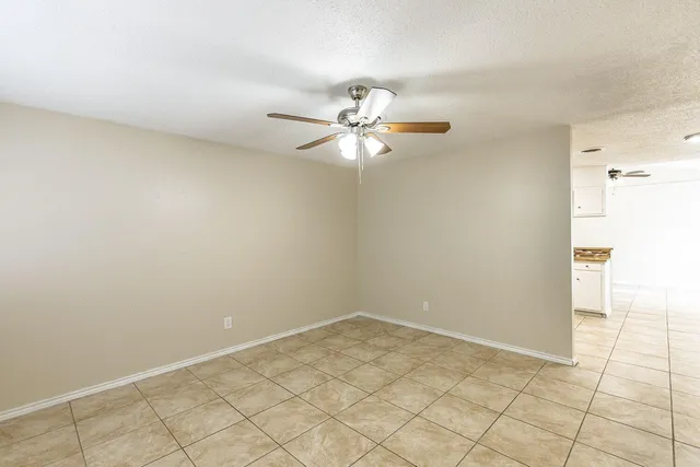 a view of a room with a ceiling fan and a fan