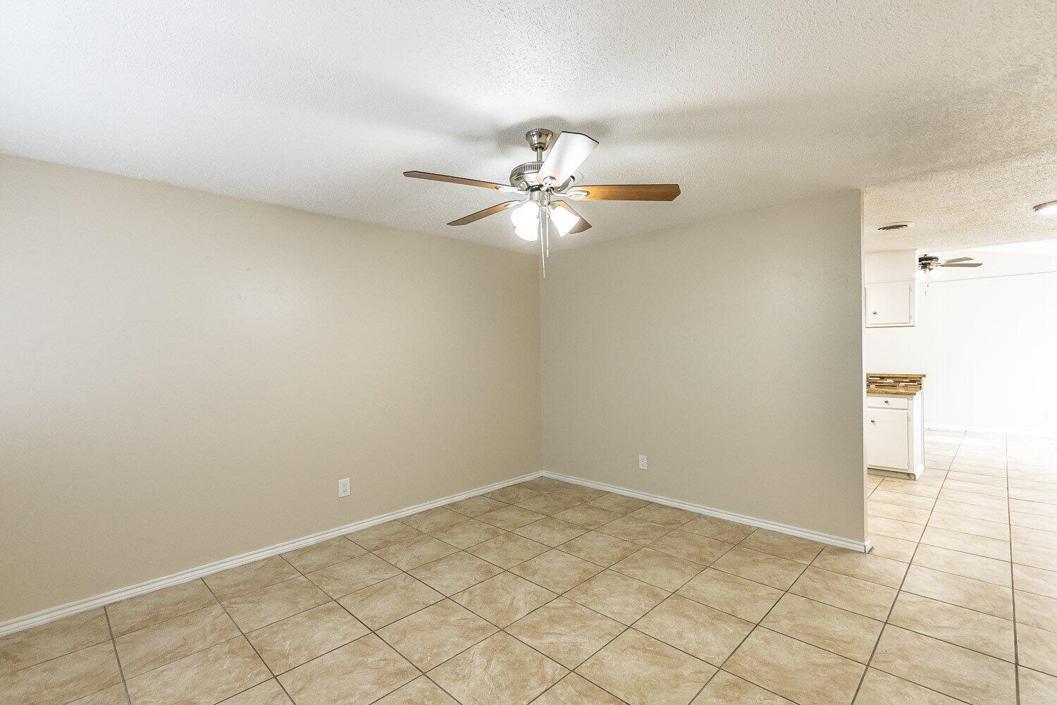 1916 71st Street Lubbock, TX 79412 - Photo 3 of 10 a view of a room with a ceiling fan and a fan