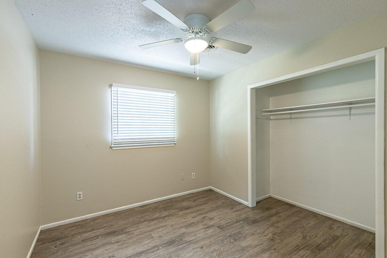 1916 71st Street Lubbock, TX 79412 - Photo 6 of 10 an empty room with fan and windows