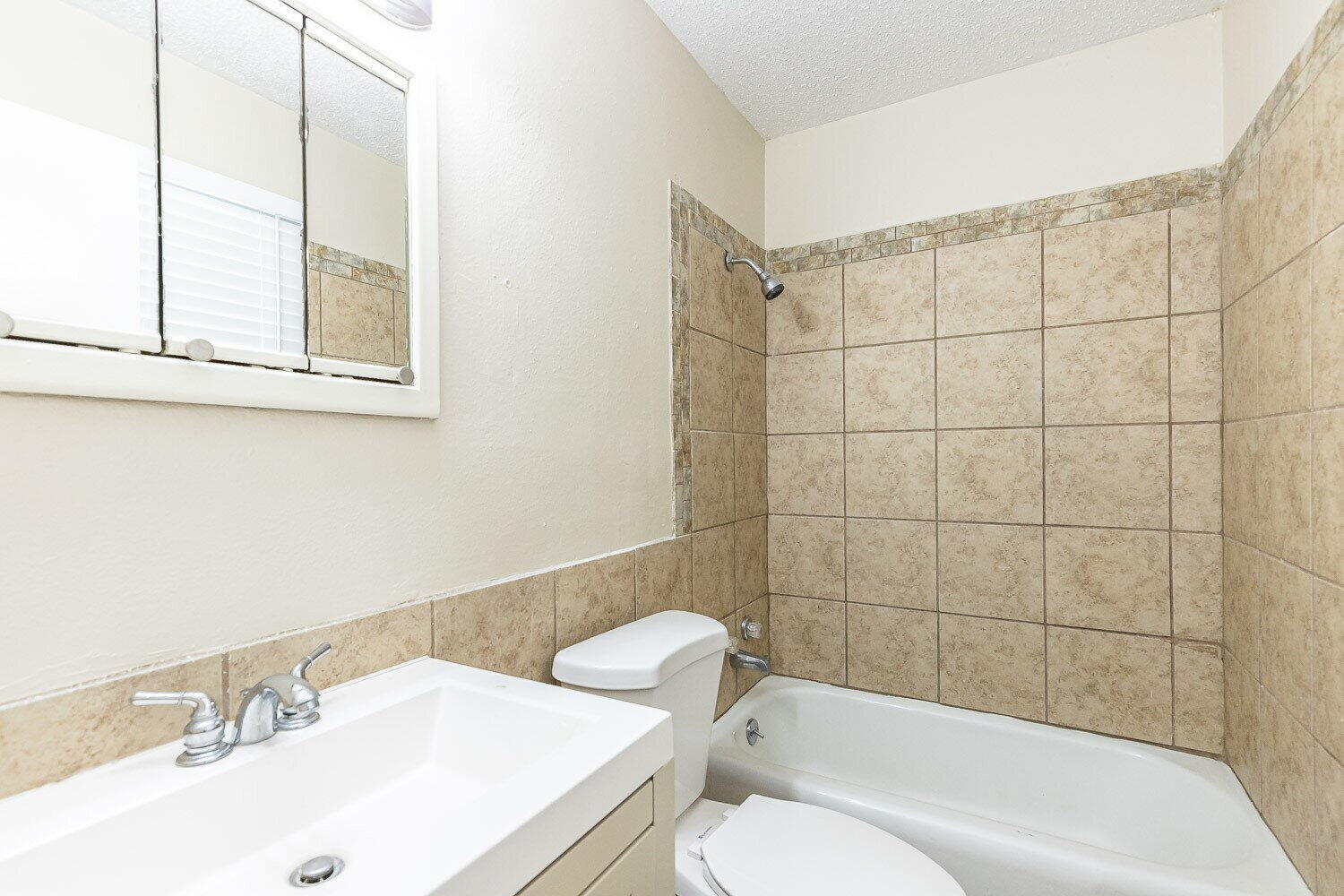 1916 71st Street Lubbock, TX 79412 - Photo 7 of 10 a bathroom with a sink toilet and shower