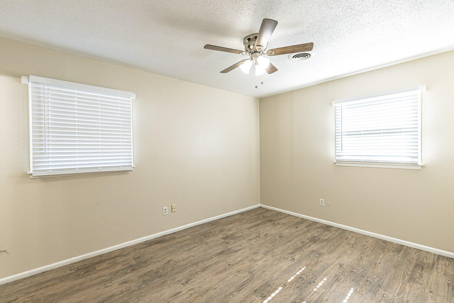 1916 71st Street Lubbock, TX 79412 - Photo 8 of 10 a view of a room with wooden floor and windows