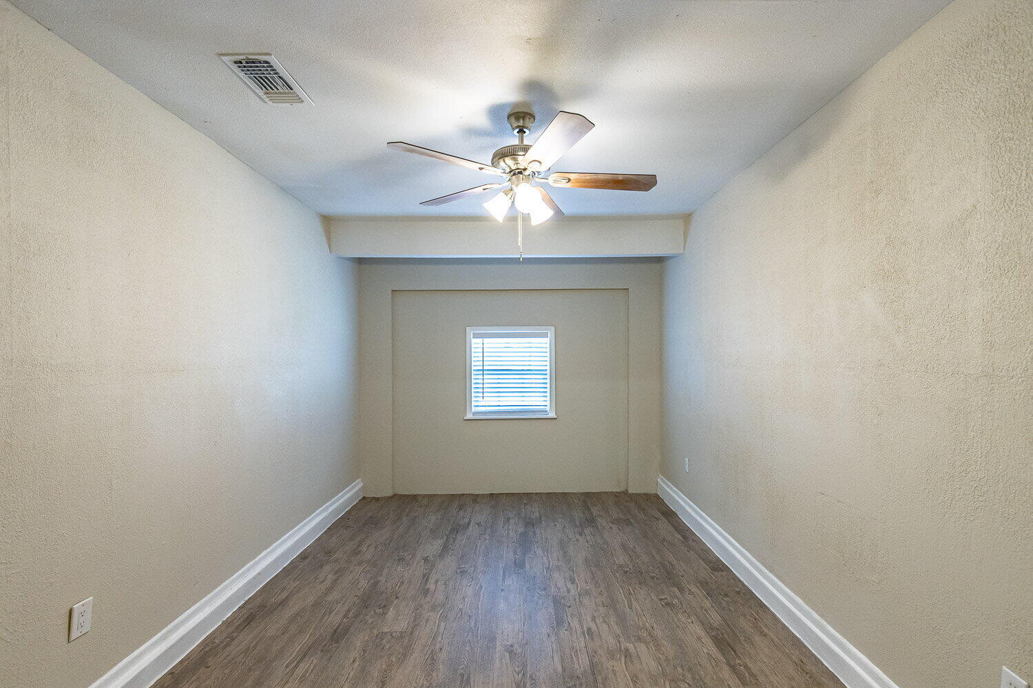 1916 71st Street Lubbock, TX 79412 - Photo 9 of 10 wooden floor in an empty room with a window
