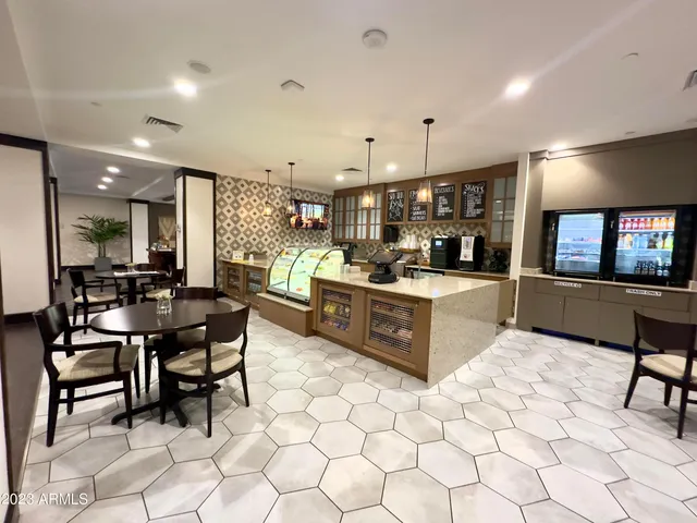 a kitchen with stainless steel appliances kitchen island granite countertop a sink a counter top space and cabinets