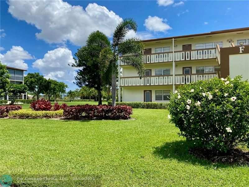 211 Mansfield East, Unit 211 Boca Raton, FL 33434 - Photo 13 of 14 a view of a building with a garden