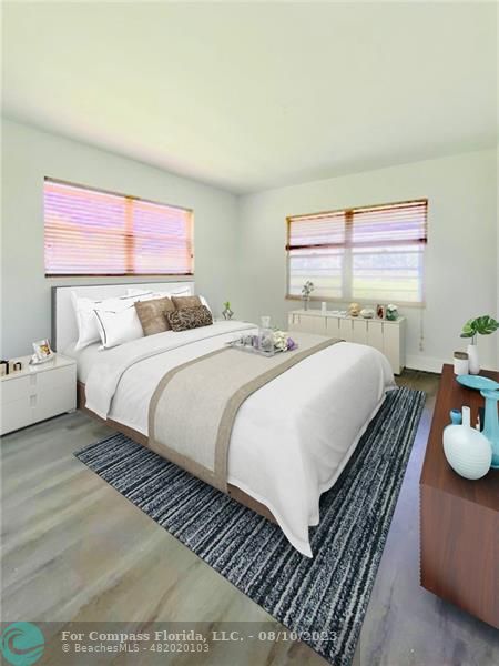 211 Mansfield East, Unit 211 Boca Raton, FL 33434 - Photo 4 of 14 a bedroom with a bed and wooden floor