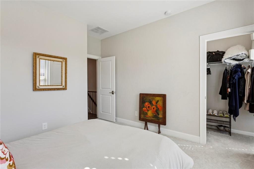 4219 Deming Circle Sandy Springs, GA 30342 - Photo 36 of 43 a bedroom with a bed and a painting on the wall