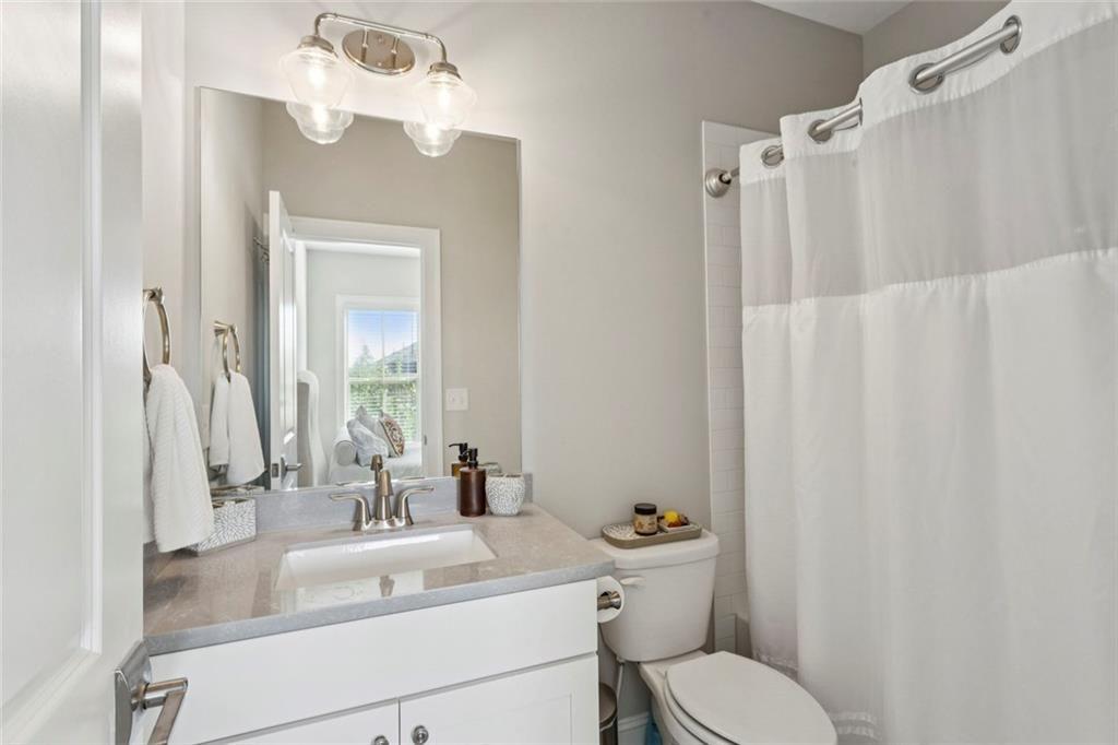 4219 Deming Circle Sandy Springs, GA 30342 - Photo 37 of 43 a bathroom with a sink vanity mirror and toilet