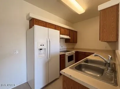 a kitchen with a refrigerator and a sink