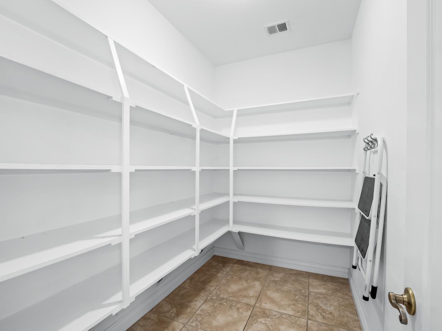 16389 Monreal Road Madera, CA 93636 - Photo 14 of 52 a storage room with a wooden floor