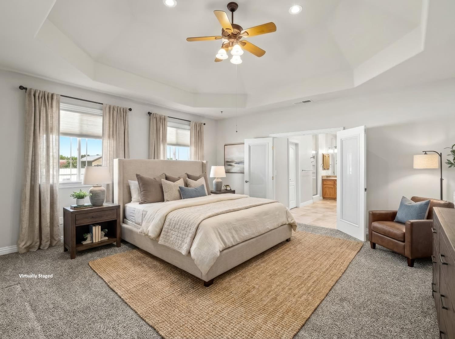 16389 Monreal Road Madera, CA 93636 - Photo 17 of 52 a spacious bedroom with a bed a couch and a chandelier