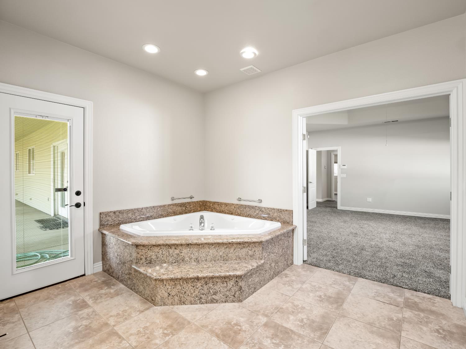 16389 Monreal Road Madera, CA 93636 - Photo 20 of 52 a view of a bathtub in a room