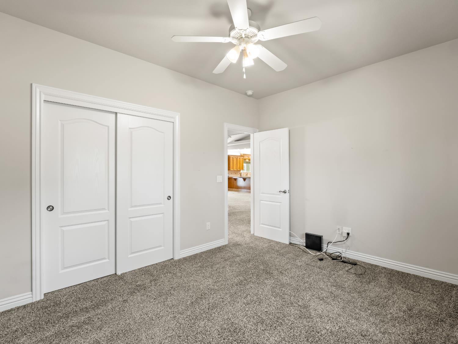 16389 Monreal Road Madera, CA 93636 - Photo 29 of 52 an empty room with closet and a ceiling fan