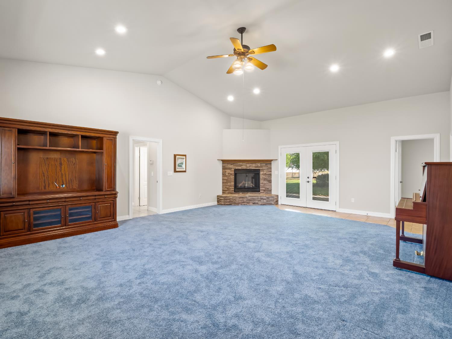 16389 Monreal Road Madera, CA 93636 - Photo 33 of 52 a view of an empty room with a fireplace and a window