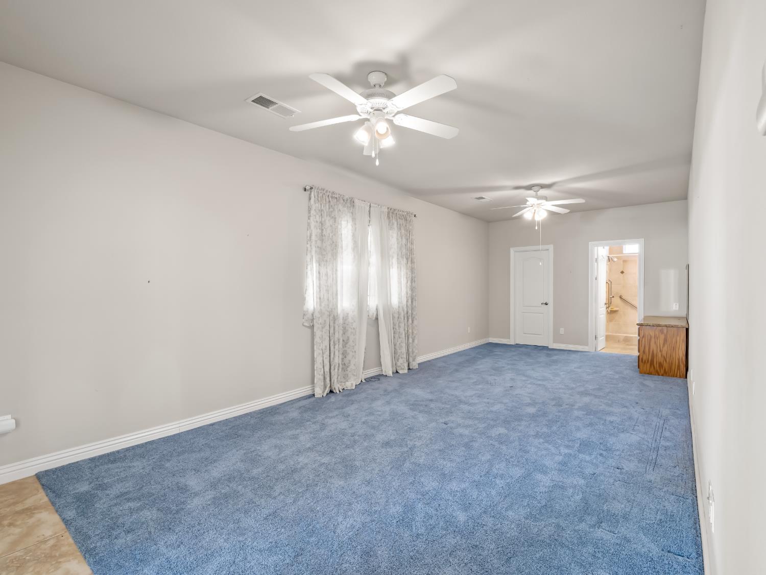 16389 Monreal Road Madera, CA 93636 - Photo 34 of 52 an empty room with fan and windows