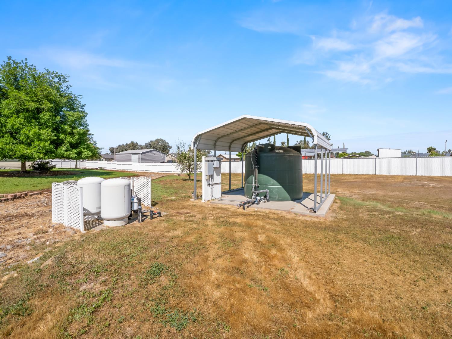 16389 Monreal Road Madera, CA 93636 - Photo 40 of 52 a view of a garden with a bench and lawn chairs