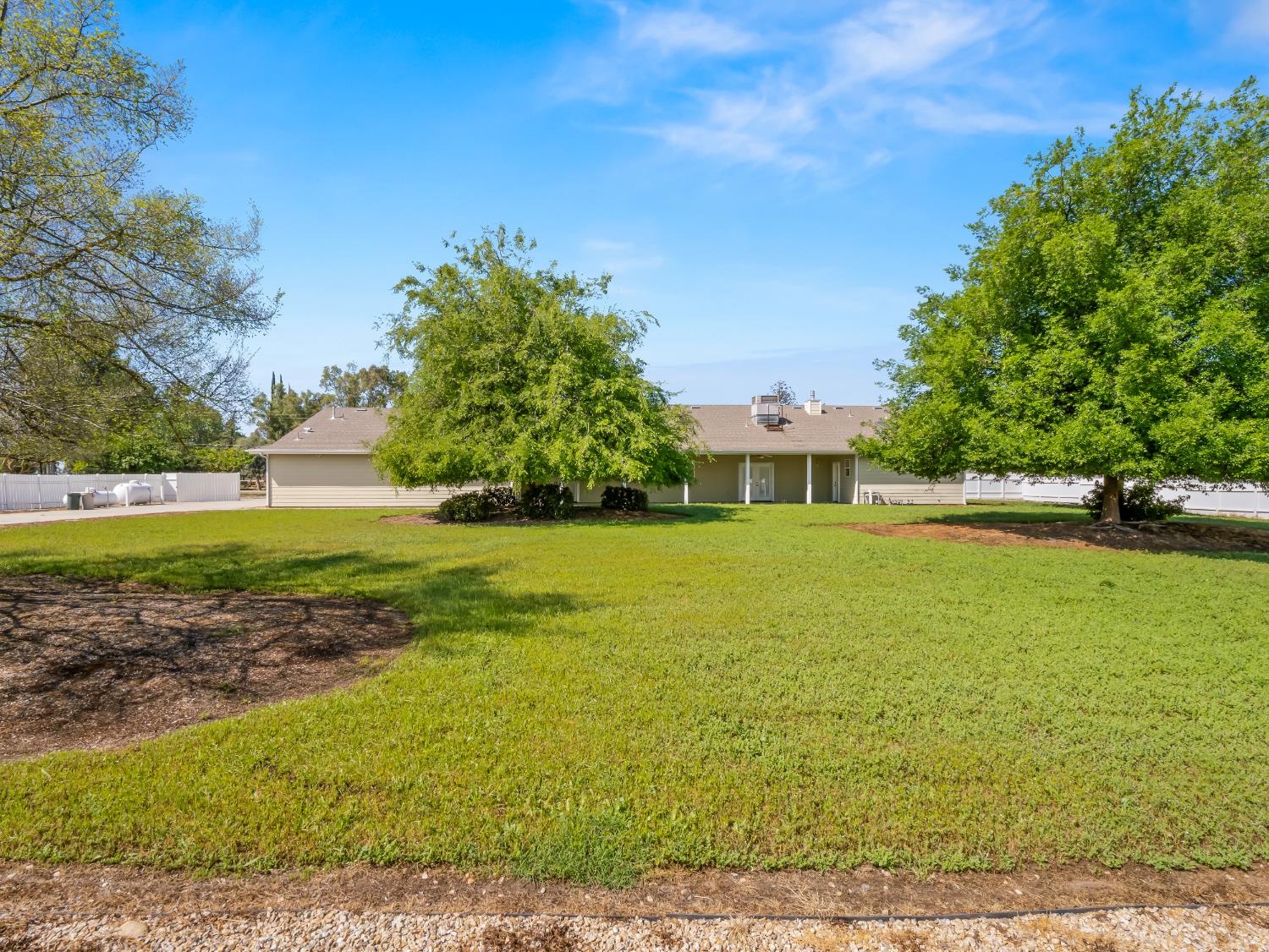 16389 Monreal Road Madera, CA 93636 - Photo 42 of 52 a front view of a house with a yard