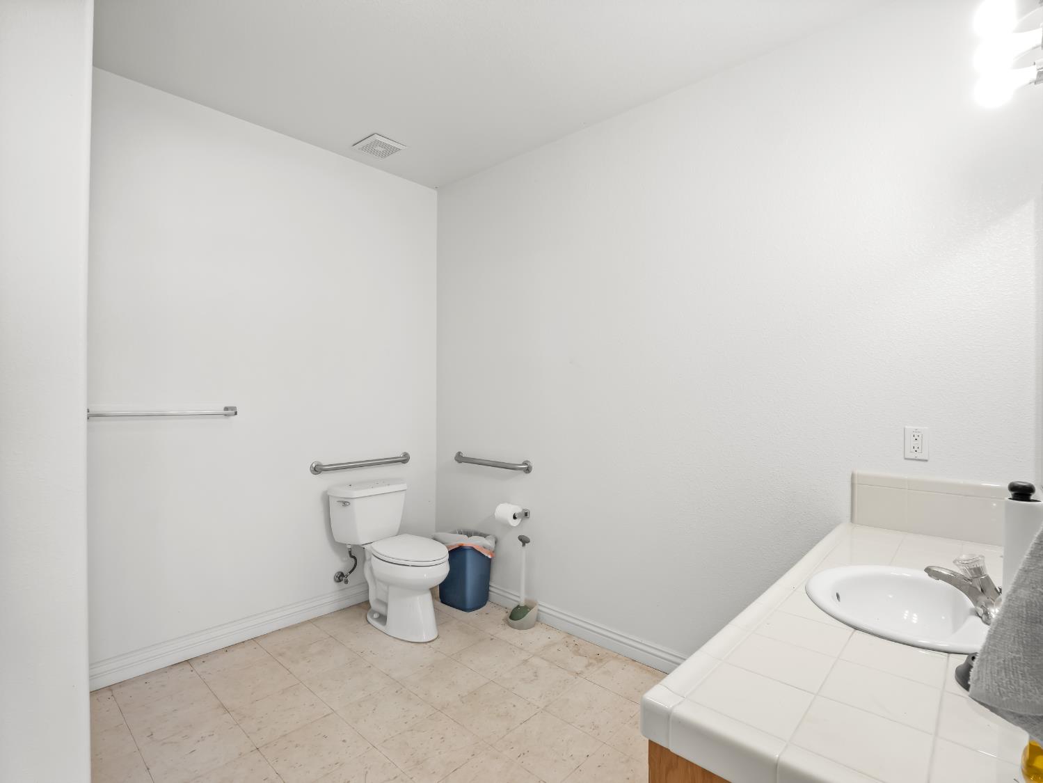 16389 Monreal Road Madera, CA 93636 - Photo 47 of 52 a bathroom with a toilet and a sink