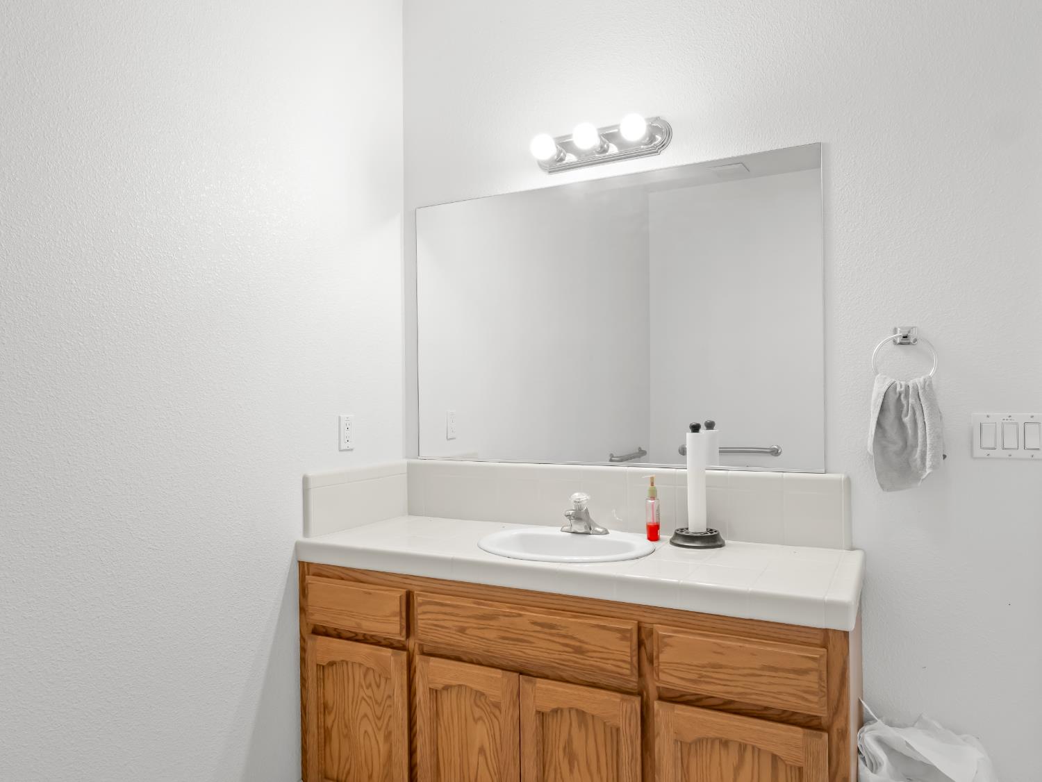 16389 Monreal Road Madera, CA 93636 - Photo 49 of 52 a bathroom with a sink and a mirror