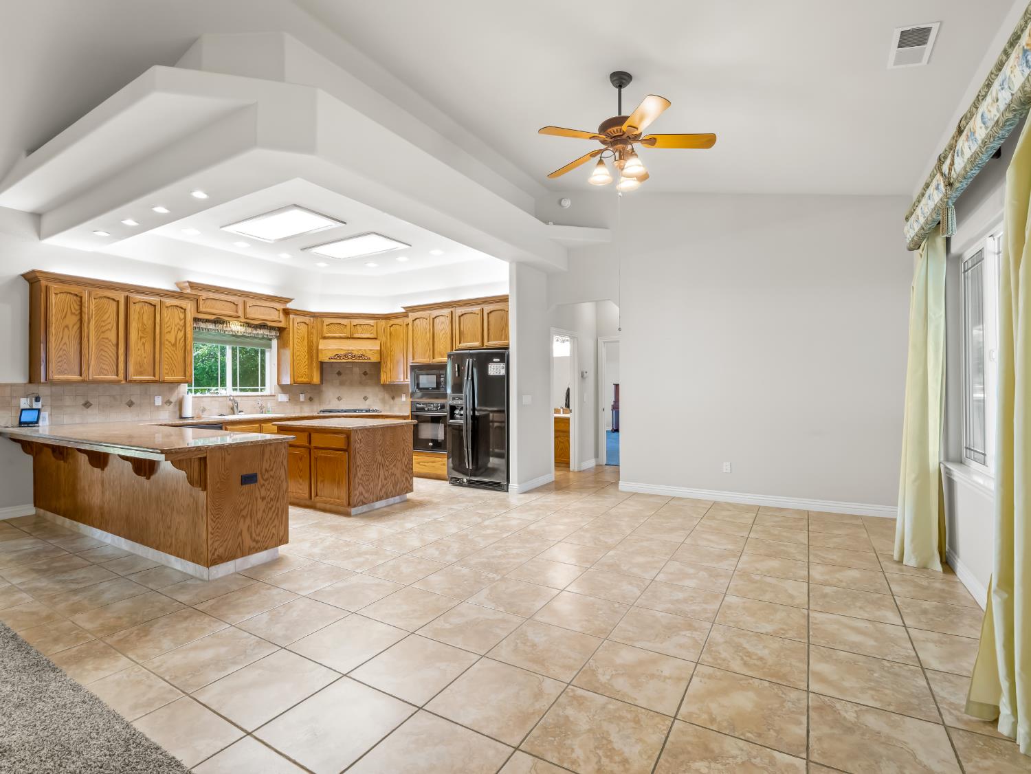 16389 Monreal Road Madera, CA 93636 - Photo 9 of 52 a view of kitchen with granite countertop cabinets and window