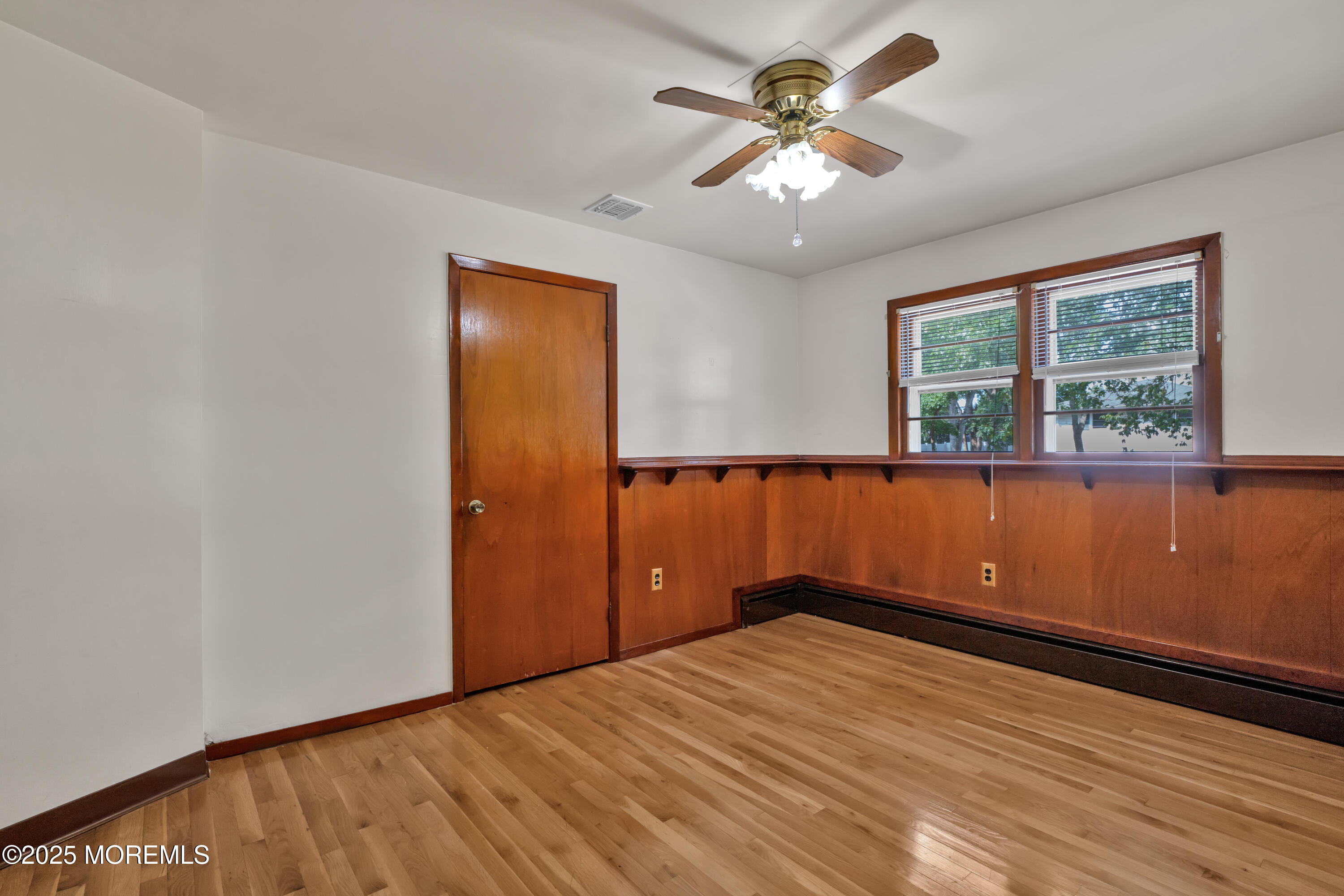 1215 Dorsett Dock Road Point Pleasant, NJ 08742 - Photo 15 of 16 a view of empty room with wooden floor and fan
