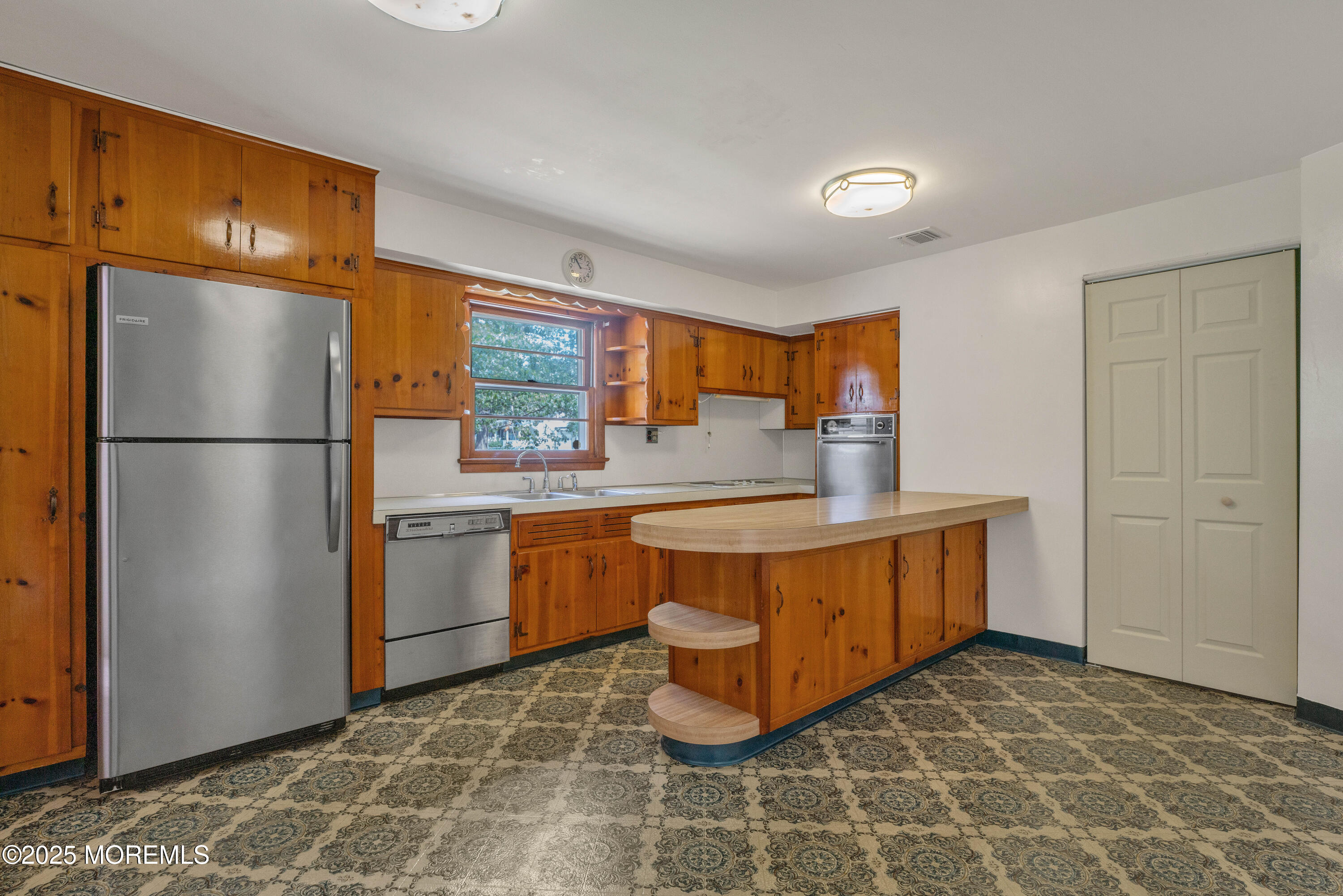 1215 Dorsett Dock Road Point Pleasant, NJ 08742 - Photo 7 of 16 a kitchen with stainless steel appliances granite countertop a refrigerator a stove a sink and dishwasher