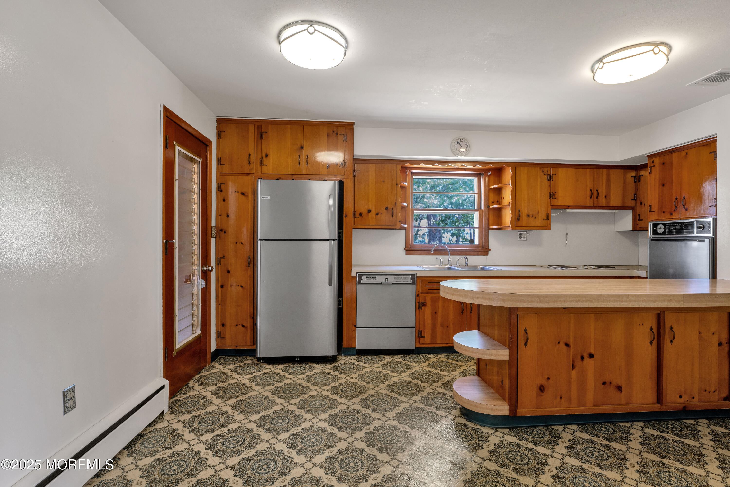 1215 Dorsett Dock Road Point Pleasant, NJ 08742 - Photo 8 of 16 a kitchen with a refrigerator and a sink
