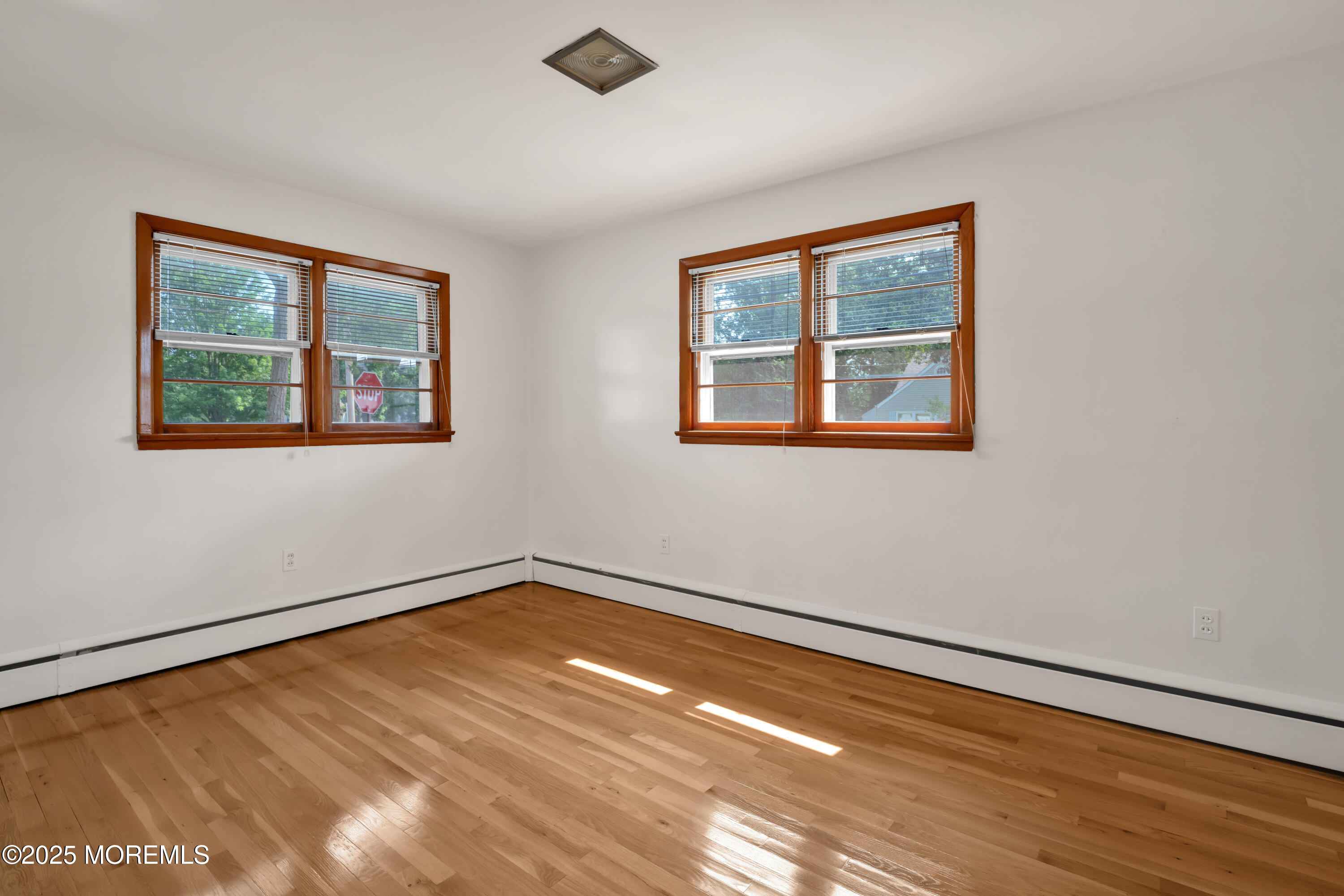 1215 Dorsett Dock Road Point Pleasant, NJ 08742 - Photo 10 of 16 a view of an empty room with wooden floor and a window