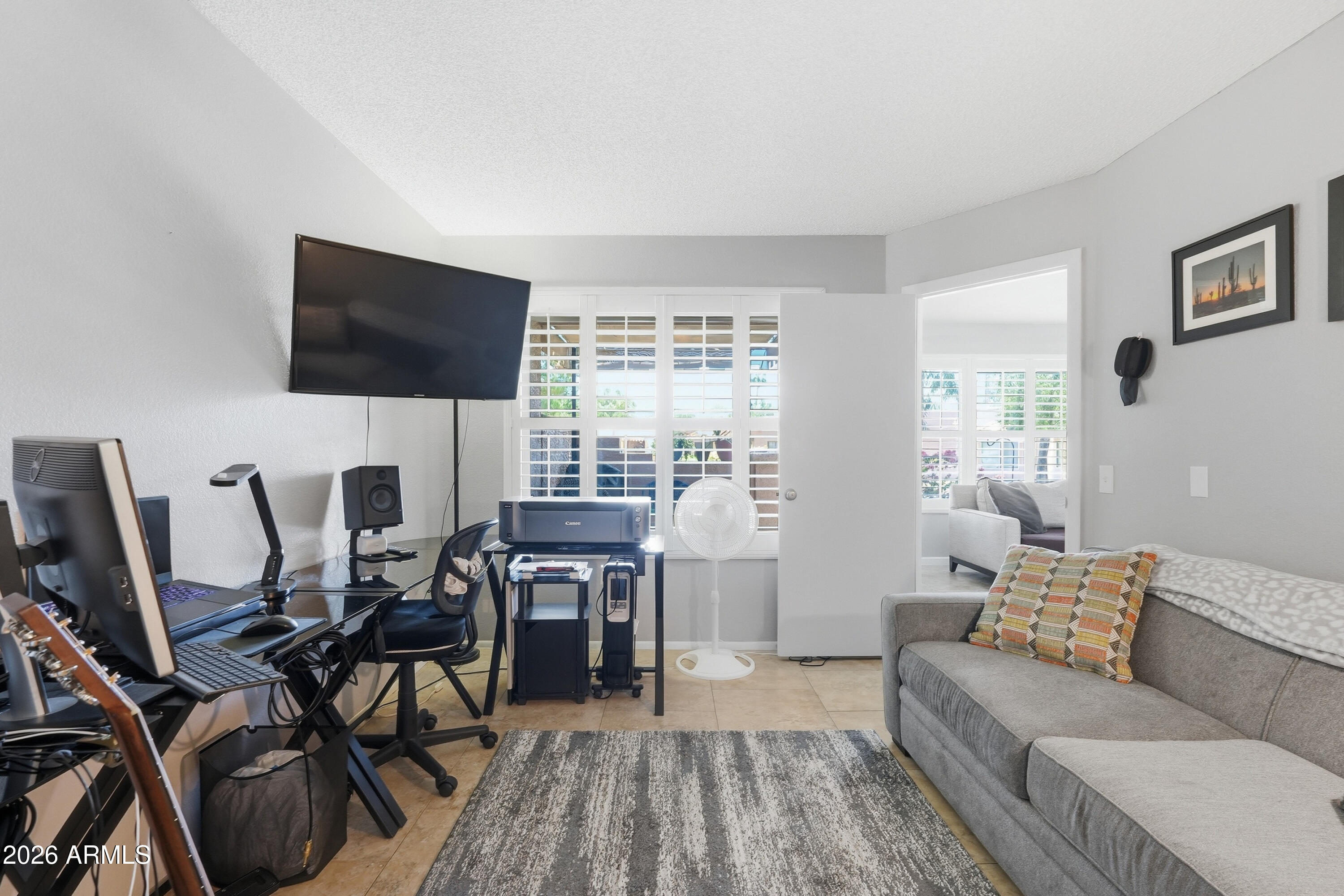 14300 West Bell Road, Unit 49 Surprise, AZ 85374 - Photo 10 of 19 a living room with furniture a flat screen tv and a large window