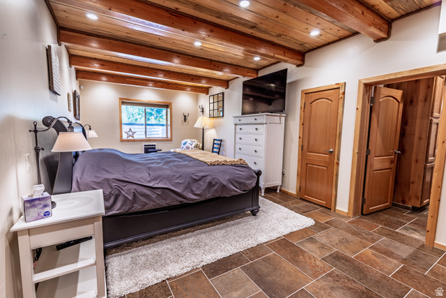 401 North Aoki Michi Road Brian Head, UT 84719 - Photo 30 of 58 Exposed wood beam ceiling with recessed lighting, tile flooring, wood-finish doors, and a window with natural light