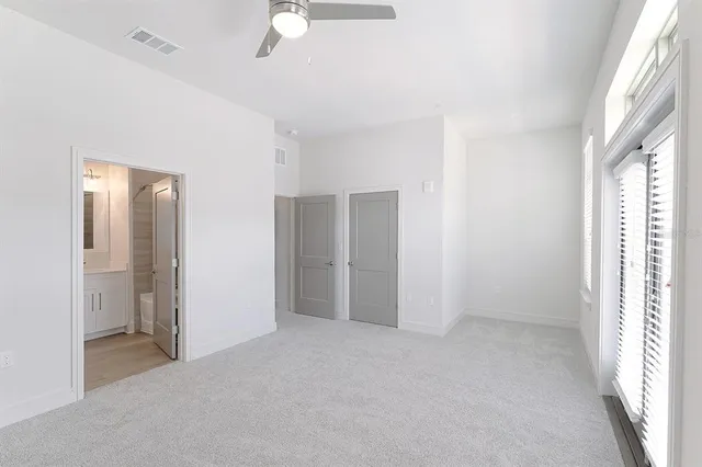 an empty room with windows and closet