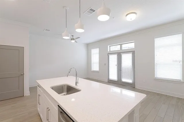 a kitchen that has a sink a stove and window