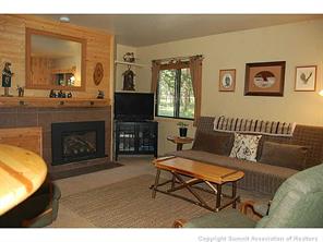 1937 Soda Ridge Road, Unit 1140 Keystone, CO 80435 - Photo 9 of 20 a living room with furniture a flat screen tv and a fireplace