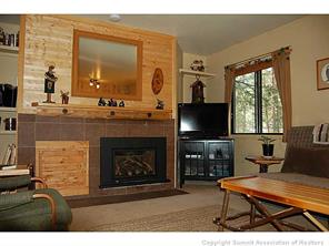 1937 Soda Ridge Road, Unit 1140 Keystone, CO 80435 - Photo 10 of 20 a living room with furniture a flat screen tv and a fireplace