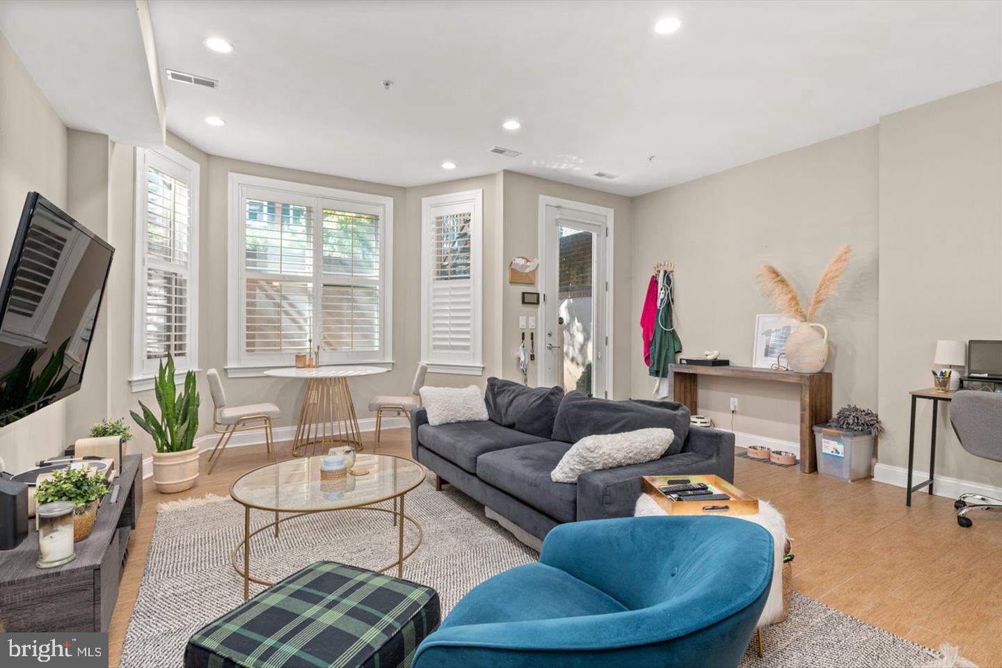 1431 Corcoran Street Northwest, Unit 1 Washington, DC 20009 - Photo 3 of 14 a living room with furniture and a flat screen tv
