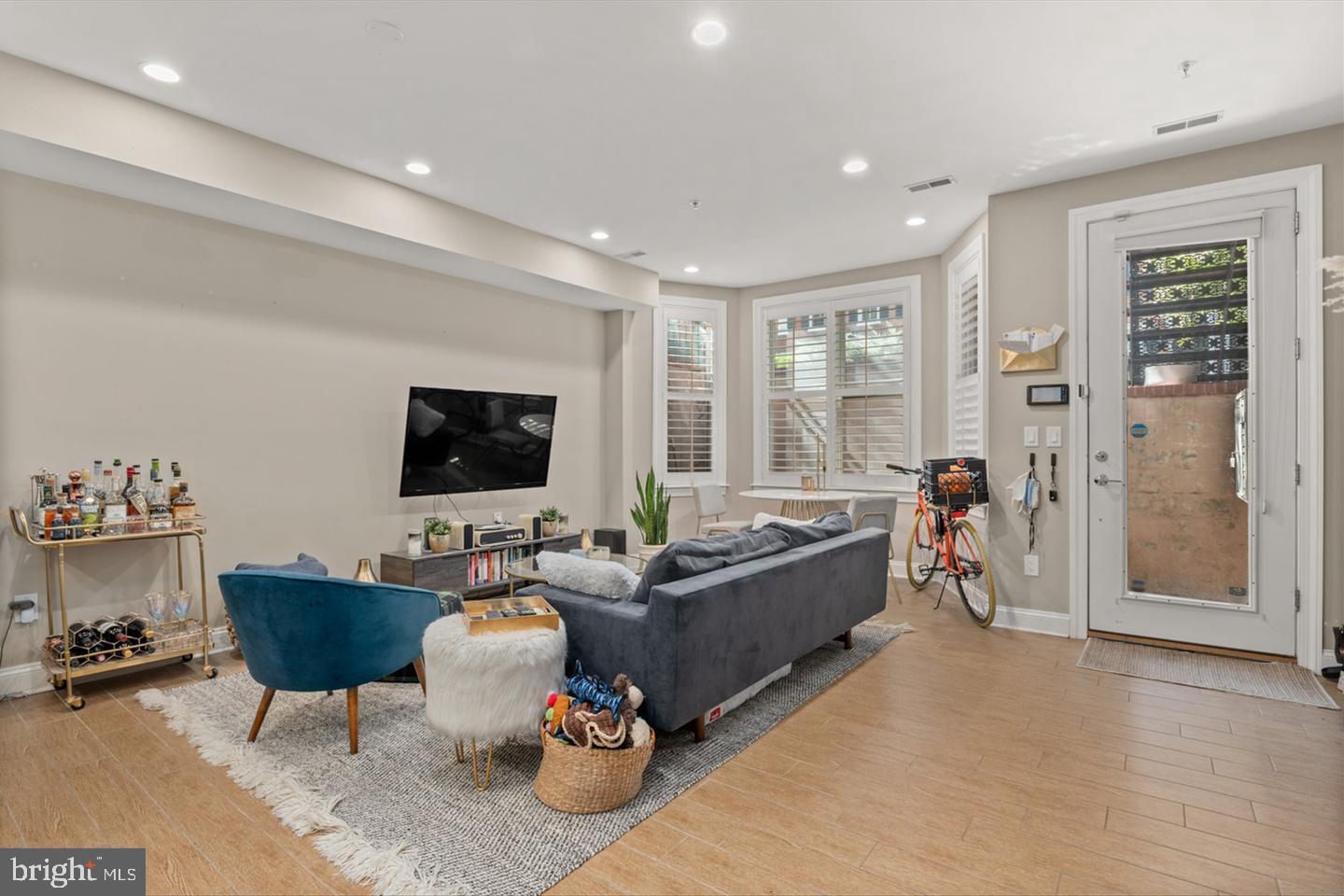 1431 Corcoran Street Northwest, Unit 1 Washington, DC 20009 - Photo 7 of 14 a living room with furniture and a flat screen tv