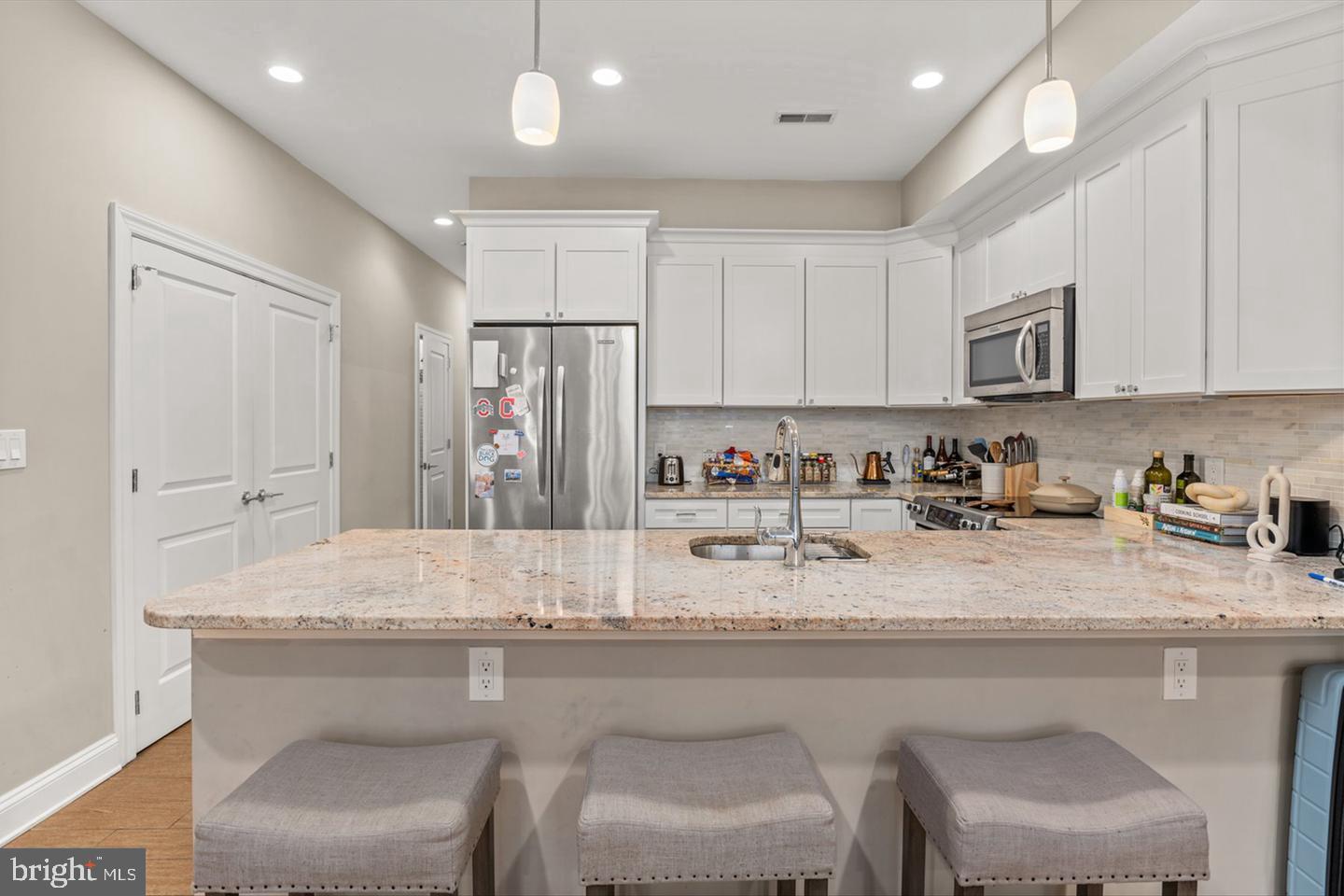 1431 Corcoran Street Northwest, Unit 1 Washington, DC 20009 - Photo 9 of 14 a kitchen with granite countertop a sink cabinets and wooden floor