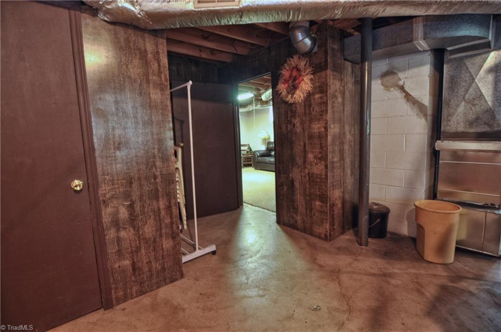 198 Yountz Road Lexington, NC 27292 - Photo 28 of 30 Partially finished basement; large closet at near left.