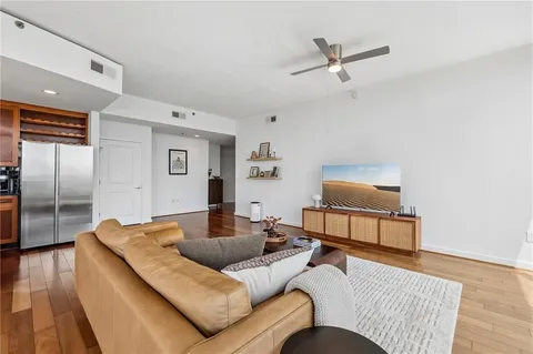 a living room with furniture and a wooden floor