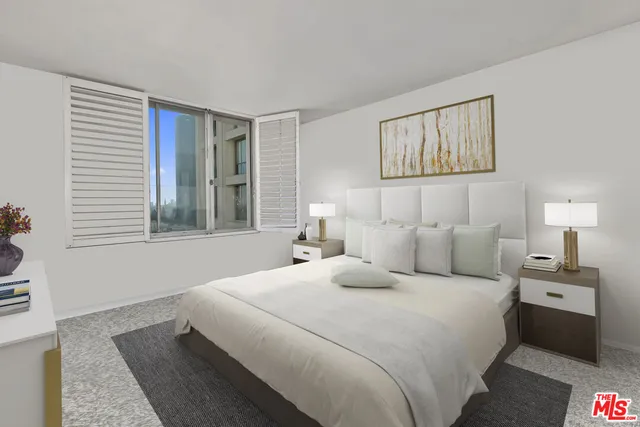 a bedroom with a large bed and a window