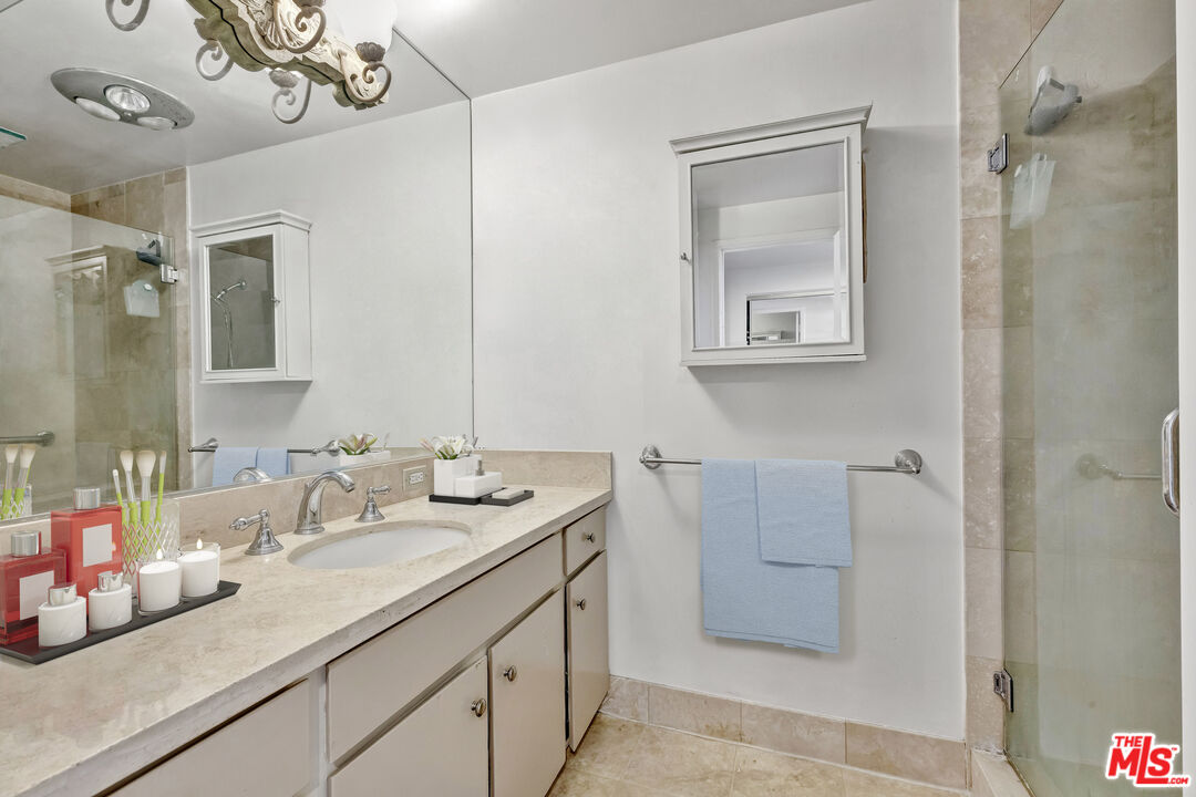 2170 Century Park East, Unit 1507 Los Angeles, CA 90067 - Photo 9 of 17 a bathroom with a double vanity sink and a mirror
