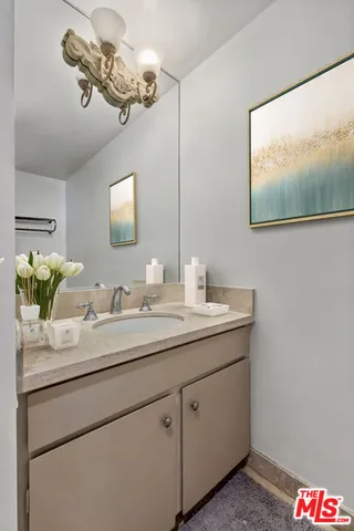 a bathroom with a double vanity sink and a mirror